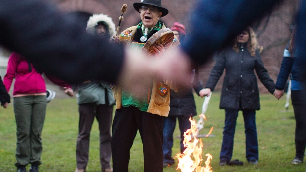 Grassy Narrows members have "developed long-term relationships with allies and activists all over the world" while addressing the adverse impacts of mercury poisoning and clear cutting on their First Nation, writes Leanne Simpson. In photo, Gary Sault of the Mississaugas of the New Credit First Nation stands in front of a sacred fire during a Grassy Narrows protest outside Queen's Park in Toronto in 2012.