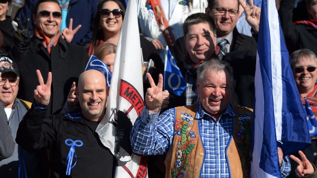 David Chartrand, president of the Manitoba Métis Federation, front right, and Will Goodon, minister of housing for the Manitoba Métis Federation, left, take part in a group photo prior to a decision at the Supreme Court of Canada in Ottawa on Thursday.